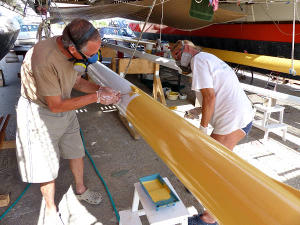 Painting masts under Gaia deck