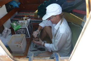Hanneke mixing epoxy in the deckpod