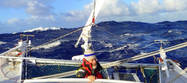 Don Brazier at the helm of Katipo in high seas