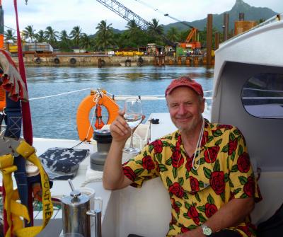 Don with a glass of drink aboard Katipo in harbour