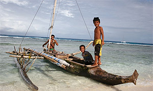 Children on an outrigger canoe