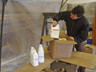 Michael unpacking bottles from a box