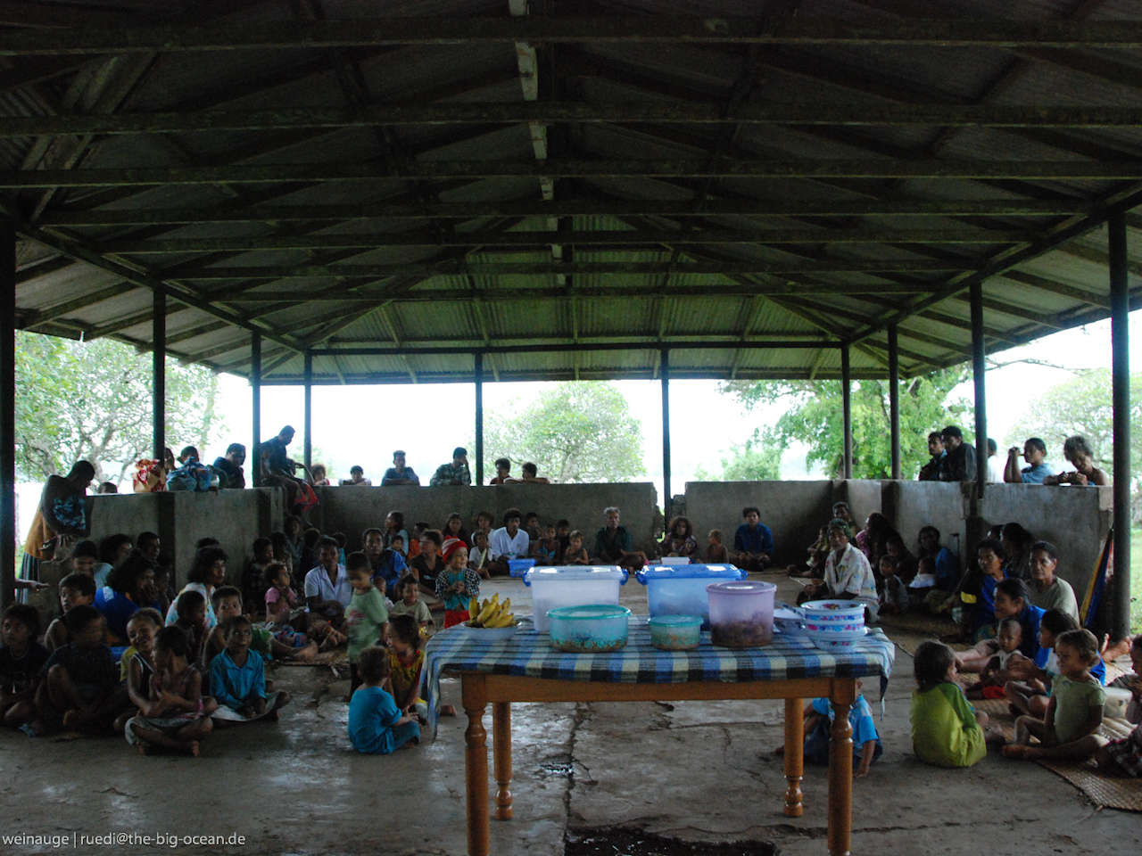 Villagers gathered under a roof