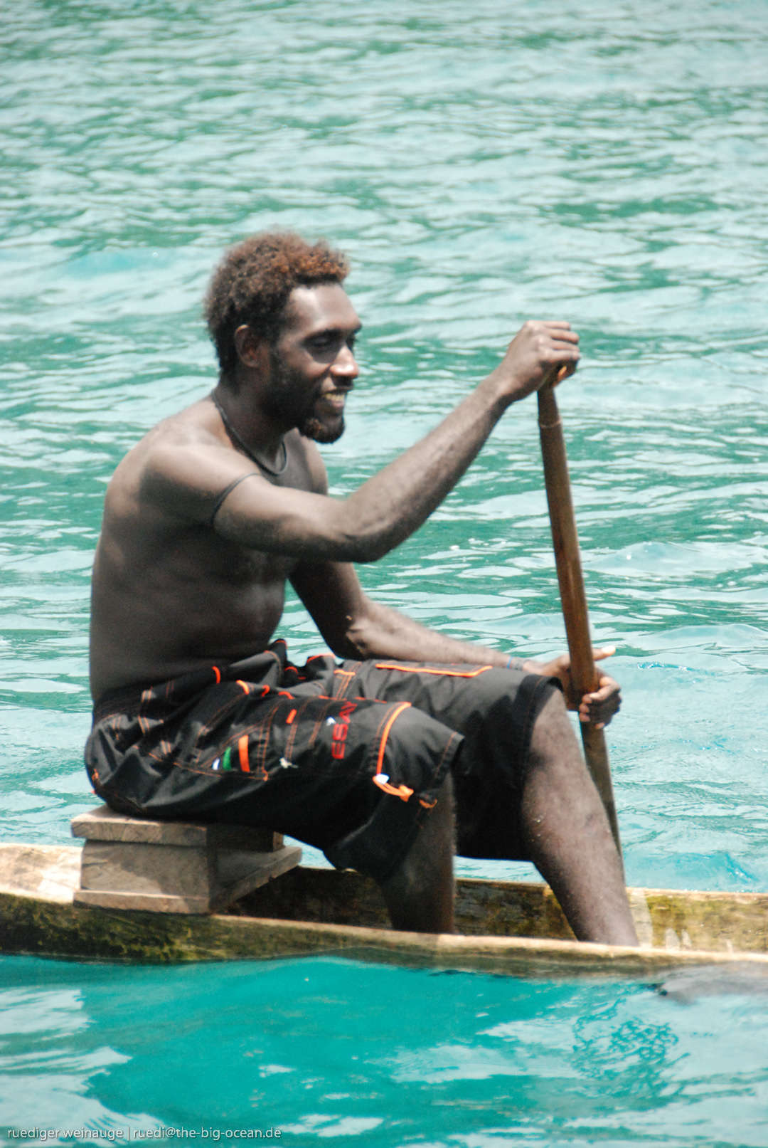 An islander paddling a canoe
