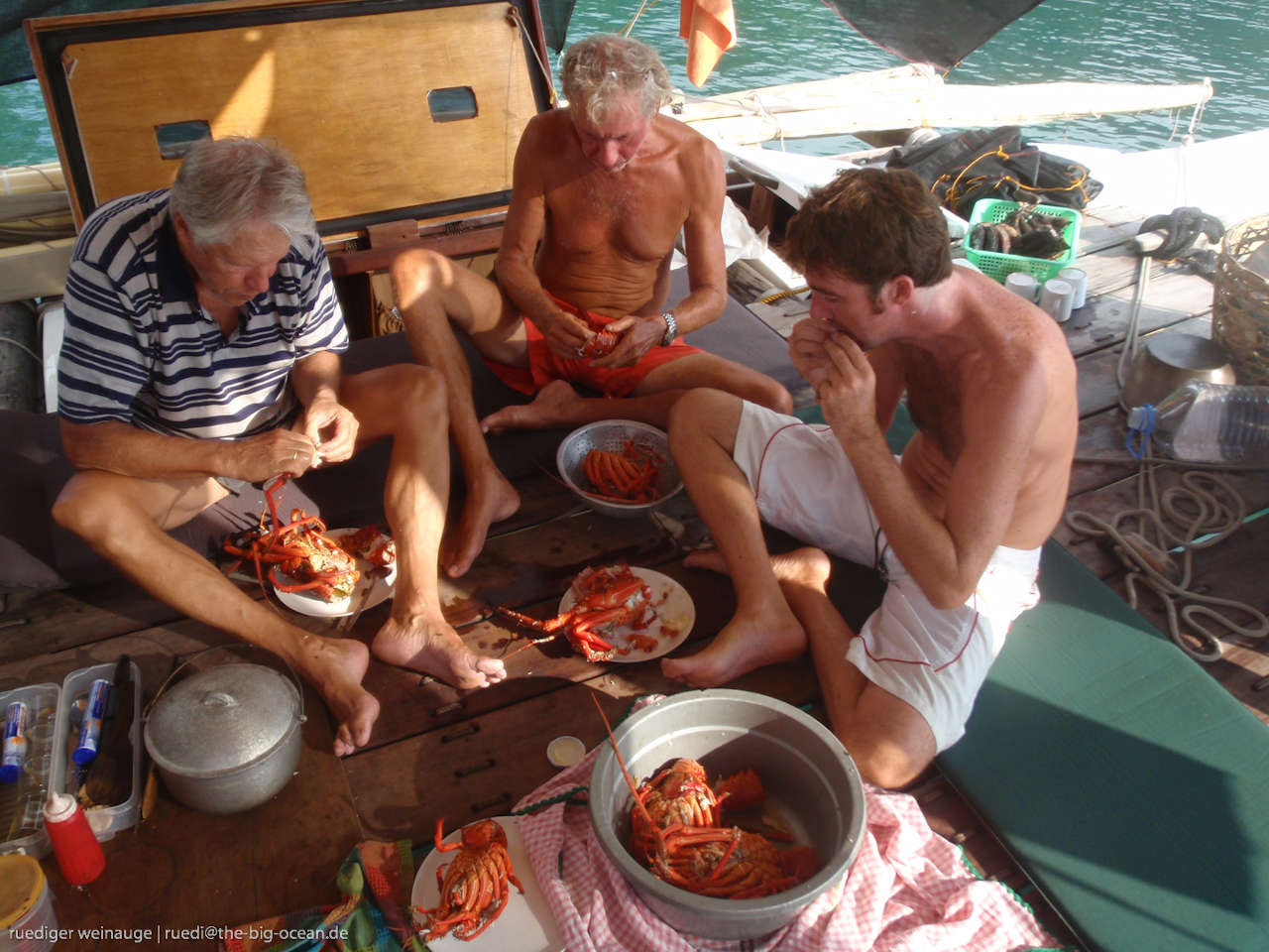 Crew eating lobsters on deck
