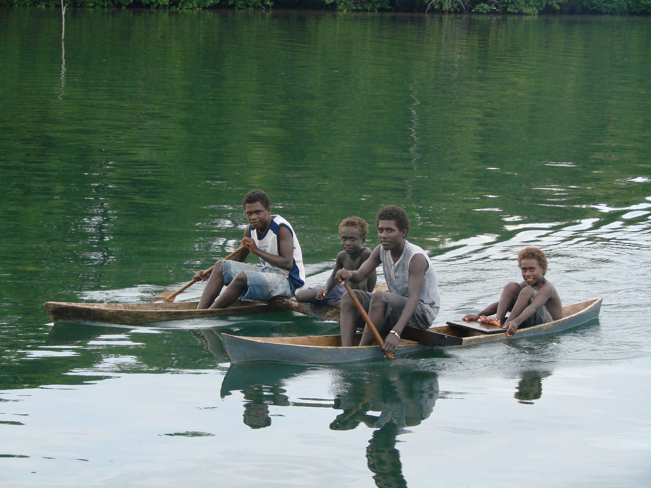 Locals paddling a double canoe