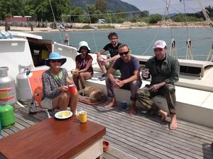 The crew sitting on deck, enjoying refreshments