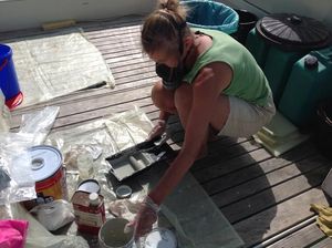 Amanda wearing facemask, with bucket of paint and roller tray