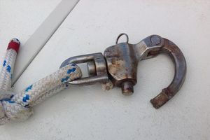 A broken stainless steel shackle with rope attached