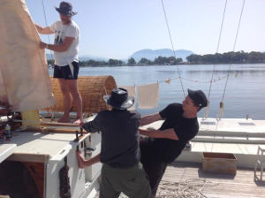 James with two helpers hoisting sails