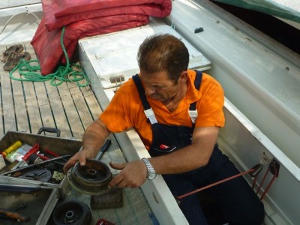 A mechanic working on an engine
