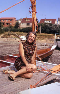 Ruth Wharram on the deck of a beached catamaran