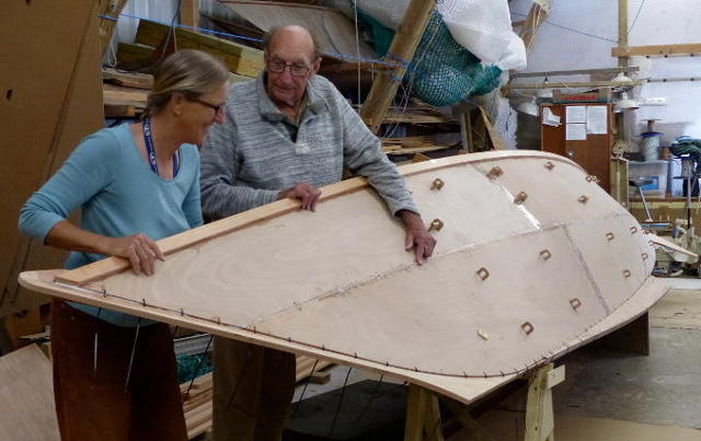 James and Hanneke inspecting a boat hull in a workshop