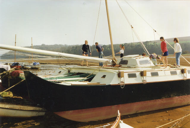 Pahi 42 on the beach with people aboard